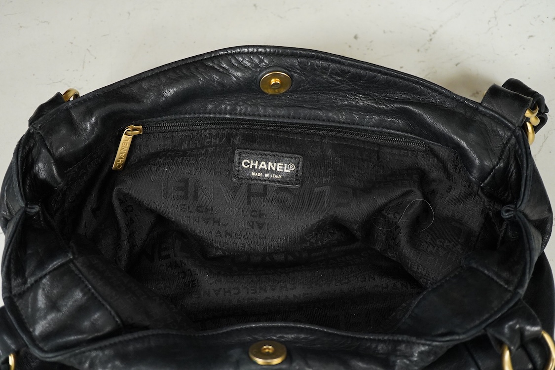 An early 2000’s Chanel black leather handbag with gold hardware, date code 7949937, 31cm wide